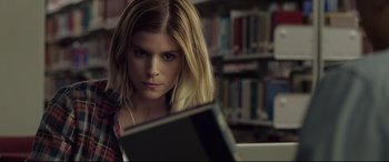 Movie still from “Fantastic Four” (2015), directed by Josh Trank – A woman is sitting in front of an open book; Close Up shot, Over the shoulder angle