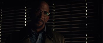 Movie still from “Fantastic Four” (2015), directed by Josh Trank – A bald man with glasses and a jacket; Close Up shot, Low angle