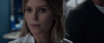 Movie still from “Fantastic Four” (2015), directed by Josh Trank – A woman's face in a white shirt; Close Up shot, Over the shoulder angle