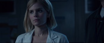 Movie still from “Fantastic Four” (2015), directed by Josh Trank – A woman in a white jacket is looking to her left; Close Up shot, Low angle