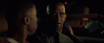 Movie still from “Fantastic Four” (2015), directed by Josh Trank – A man with glasses and a beard is sitting in a car; Close Up shot, Over the shoulder angle