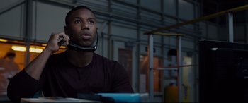 Movie still from “Fantastic Four” (2015), directed by Josh Trank – A man with a headset around his neck looks upward; Close Up shot, Low angle