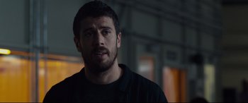 Movie still from “Fantastic Four” (2015), directed by Josh Trank – A person wearing a black t - shirt; Close Up shot, Over the shoulder angle