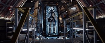 Movie still from “Fantastic Four” (2015), directed by Josh Trank – A man is standing inside of an elevator; Wide shot, Overhead angle