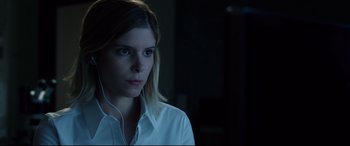 Movie still from “Fantastic Four” (2015), directed by Josh Trank – A young woman wearing a white button up shirt; Close Up shot, Over the shoulder angle