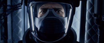 Movie still from “Fantastic Four” (2015), directed by Josh Trank – A man wearing a gas mask in the dark; Close Up shot, Overhead angle