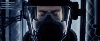 Movie still from “Fantastic Four” (2015), directed by Josh Trank – A man wearing a gas mask in the dark; Close Up shot, Overhead angle