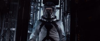 Movie still from “Fantastic Four” (2015), directed by Josh Trank – A man wearing a suit and helmet in a room; Medium shot, Low angle