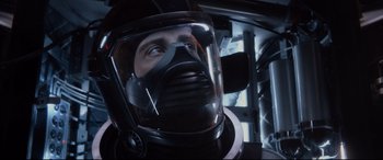 Movie still from “Fantastic Four” (2015), directed by Josh Trank – A man wearing a black helmet and a black mask; Close Up shot, Over the shoulder angle