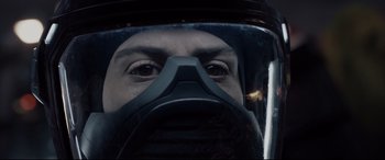 Movie still from “Fantastic Four” (2015), directed by Josh Trank – A man wearing a gas mask looking into the camera; Close Up shot, Overhead angle