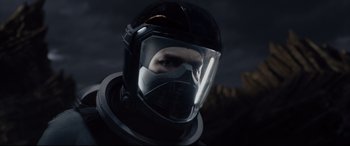 Movie still from “Fantastic Four” (2015), directed by Josh Trank – A person wearing a helmet and a black suit; Close Up shot, Low angle