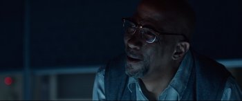 Movie still from “Fantastic Four” (2015), directed by Josh Trank – A person wearing glasses; Close Up shot, Over the shoulder angle
