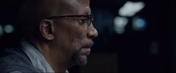 Movie still from “Fantastic Four” (2015), directed by Josh Trank – A person wearing glasses; Close Up shot, Over the shoulder angle