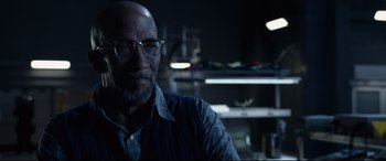 Movie still from “Fantastic Four” (2015), directed by Josh Trank – An older man wearing glasses in a dark room; Close Up shot, Over the shoulder angle