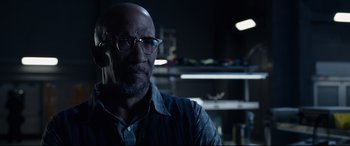 Movie still from “Fantastic Four” (2015), directed by Josh Trank – A man with glasses is looking at the camera; Close Up shot, Over the shoulder angle
