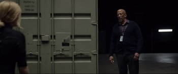 Movie still from “Fantastic Four” (2015), directed by Josh Trank – A man standing in front of an open door; Medium shot, Low angle