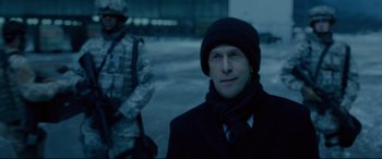 Movie still from “Fantastic Four” (2015), directed by Josh Trank – A man in a black coat and a black hat; Close Up shot, Over the shoulder angle