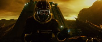 Movie still from “Fantastic Four” (2015), directed by Josh Trank – A man in a space suit is holding something in his hand; Close Up shot, Over the shoulder angle