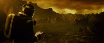 Movie still from “Fantastic Four” (2015), directed by Josh Trank – A person standing in front of a mountain range; Wide shot, High angle