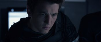 Movie still from “Fantastic Four” (2015), directed by Josh Trank – A person wearing a black jacket; Close Up shot, Over the shoulder angle