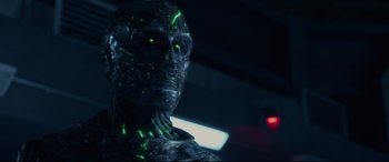 Movie still from “Fantastic Four” (2015), directed by Josh Trank – The face of an alien with glowing green eyes; Close Up shot, Low angle
