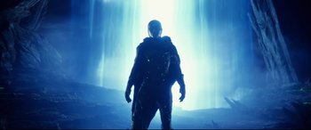 Movie still from “Fantastic Four” (2015), directed by Josh Trank – A man standing in front of a waterfall in the dark; Wide shot, Low angle