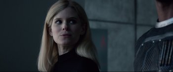 Movie still from “Fantastic Four” (2015), directed by Josh Trank – A woman with long blonde hair wearing a black shirt; Close Up shot, Over the shoulder angle