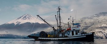 Movie still from “Fantastic Four: Rise of the Silver Surfer” (2007), directed by Tim Story – A fishing boat is in the water near mountains; Extreme Wide shot, Low angle