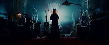 Movie still from “Fantastic Four: Rise of the Silver Surfer” (2007), directed by Tim Story – A person wearing a bear costume in a dark room; Wide shot, Low angle