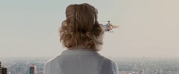 Movie still from “Fantastic Four: Rise of the Silver Surfer” (2007), directed by Tim Story – A woman with long blonde hair is looking at a helicopter; Medium shot, Over the shoulder angle