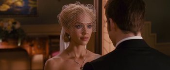 Movie still from “Fantastic Four: Rise of the Silver Surfer” (2007), directed by Tim Story – A woman wearing a veil standing next to a man wearing a suit; Close Up shot, Over the shoulder angle