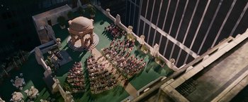 Movie still from “Fantastic Four: Rise of the Silver Surfer” (2007), directed by Tim Story – An aerial view of a wedding ceremony in a building; Extreme Wide shot, Overhead angle