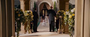 Movie still from “Fantastic Four: Rise of the Silver Surfer” (2007), directed by Tim Story – Two men and a little girl walking down the aisle of a church; Wide shot, High angle