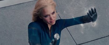 Movie still from “Fantastic Four: Rise of the Silver Surfer” (2007), directed by Tim Story – A woman dressed in a blue suit with a white and blue emblem on her chest; Close Up shot, Overhead angle