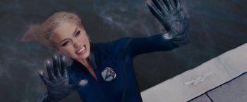 Movie still from “Fantastic Four: Rise of the Silver Surfer” (2007), directed by Tim Story – A woman in a blue suit waving at the camera; Close Up shot, Overhead angle