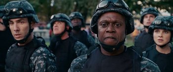 Movie still from “Fantastic Four: Rise of the Silver Surfer” (2007), directed by Tim Story – A group of men in military fatigues standing in a line; Close Up shot, Low angle