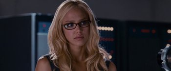 Movie still from “Fantastic Four: Rise of the Silver Surfer” (2007), directed by Tim Story – A woman wearing glasses and a black top; Close Up shot, Over the shoulder angle