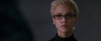 Movie still from “Fantastic Four: Rise of the Silver Surfer” (2007), directed by Tim Story – A woman wearing glasses and a black shirt; Close Up shot, Over the shoulder angle