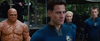 Movie still from “Fantastic Four: Rise of the Silver Surfer” (2007), directed by Tim Story – A man wearing a blue and black costume; Close Up shot, Over the shoulder angle