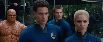 Movie still from “Fantastic Four: Rise of the Silver Surfer” (2007), directed by Tim Story – A group of men standing next to each other in a room; Medium shot, Over the shoulder angle