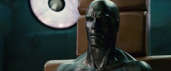Movie still from “Fantastic Four: Rise of the Silver Surfer” (2007), directed by Tim Story – A statue of a man in a chair; Close Up shot, High angle