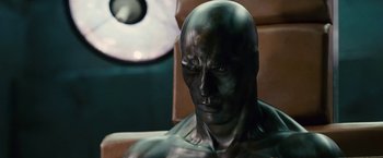Movie still from “Fantastic Four: Rise of the Silver Surfer” (2007), directed by Tim Story – A statue of a man in a chair with a lamp in the background; Close Up shot, High angle