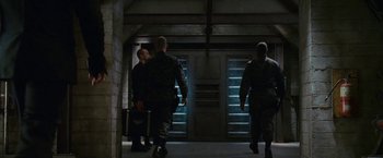 Movie still from “Fantastic Four: Rise of the Silver Surfer” (2007), directed by Tim Story – A group of men walking down a hall way; Wide shot, High angle