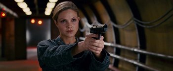 Movie still from “Fantastic Four: Rise of the Silver Surfer” (2007), directed by Tim Story – A woman is holding a gun in her hand; Close Up shot, High angle