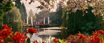 Movie still from “Fantastic Four: Rise of the Silver Surfer” (2007), directed by Tim Story – A bridge over a body of water surrounded by flowers; Extreme Wide shot, High angle