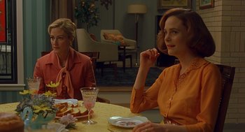 Movie still from “Far from Heaven” (2002), directed by Todd Haynes – Two women sitting at a table with plates of food in front of them; Medium shot, Over the shoulder angle