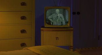 An old fashioned television set with a man on it