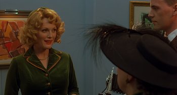 Movie still from “Far from Heaven” (2002), directed by Todd Haynes – A woman in a green dress is looking in the mirror; Close Up shot, Over the shoulder angle