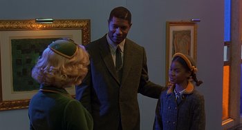 Movie still from “Far from Heaven” (2002), directed by Todd Haynes – A man and two girls are talking to each other; Medium shot, Over the shoulder angle