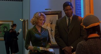 Movie still from “Far from Heaven” (2002), directed by Todd Haynes – A woman and a man standing next to each other in a room; Medium shot, Over the shoulder angle